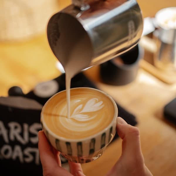 Coffee beans in wooden scoop